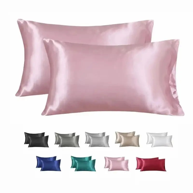 A collection of silky smooth satin pillowcases in various shades including pink, gray, beige, and red.