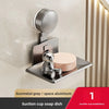 A silver wall-mounted suction cup soap dish with a bear figurine installed on a beige wall.