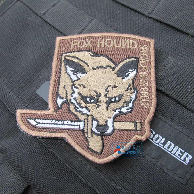 Embroidered Foxhound patch featuring a fox head and hook and loop backing on a dark fabric.