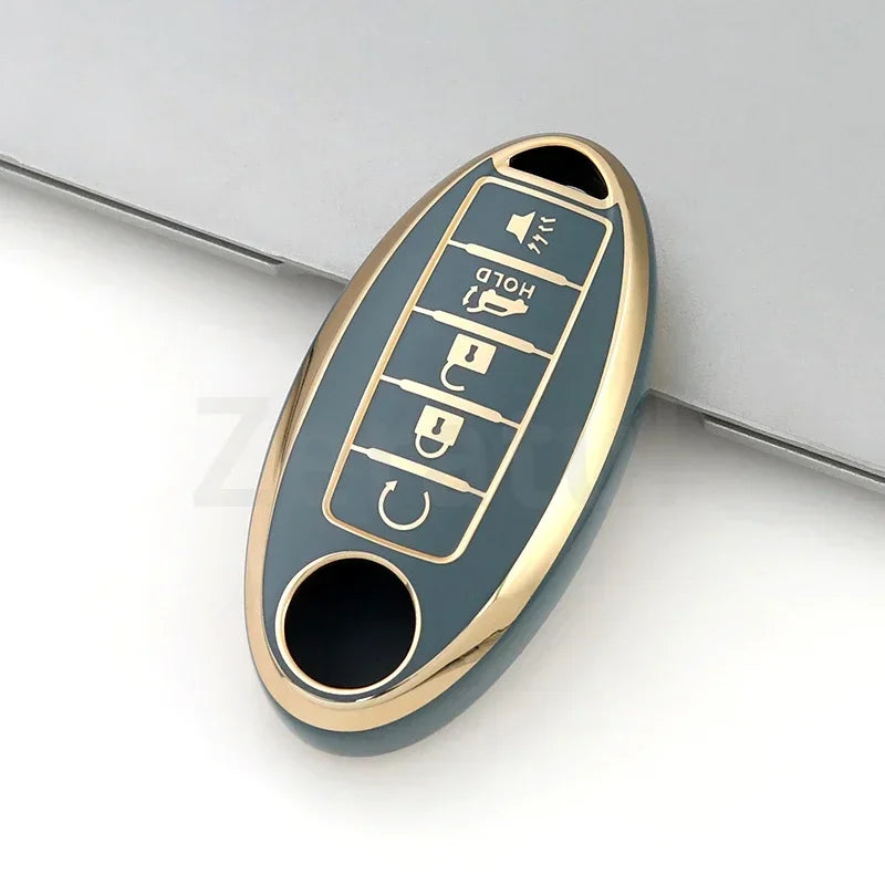 A close-up view of a gold-colored TPU car key case cover with multiple buttons and a key slot.