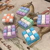 A collection of colorful tactile clicking keyboard fidget toys arranged on a textured background with horse imagery.
