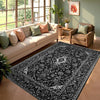 A black and white patterned cowhide print area rug in a modern Western style placed in a sunlit living room.