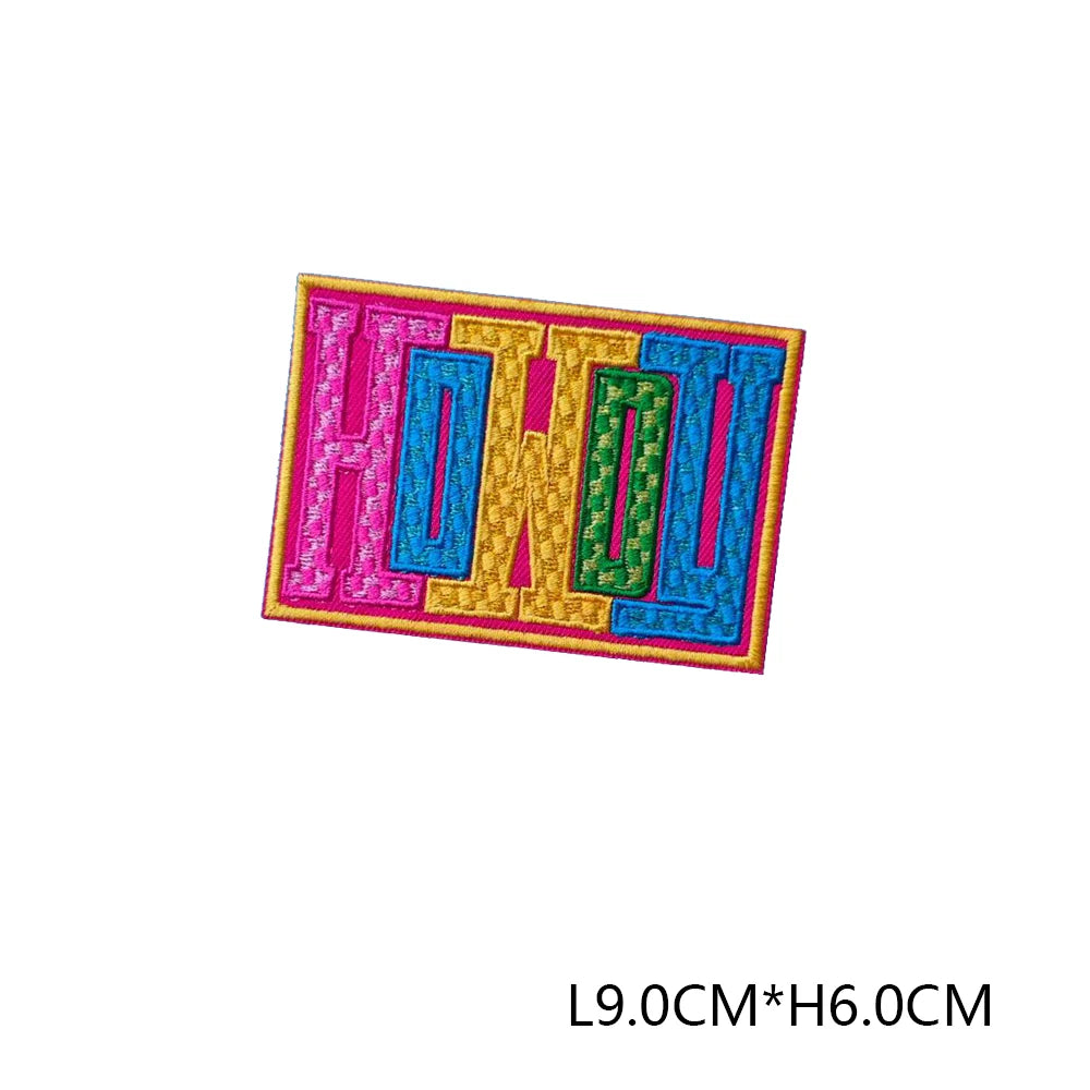 A set of embroidered letter patches spelling out HIODU in pink, blue, and green threads.