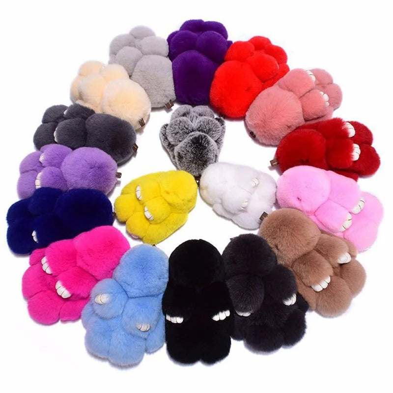 A collection of fluffy angel bunny keychains in various colors including purple, pink, red, and yellow.
