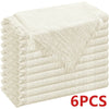 A stack of six beige raw-edge polyester cloth napkins.