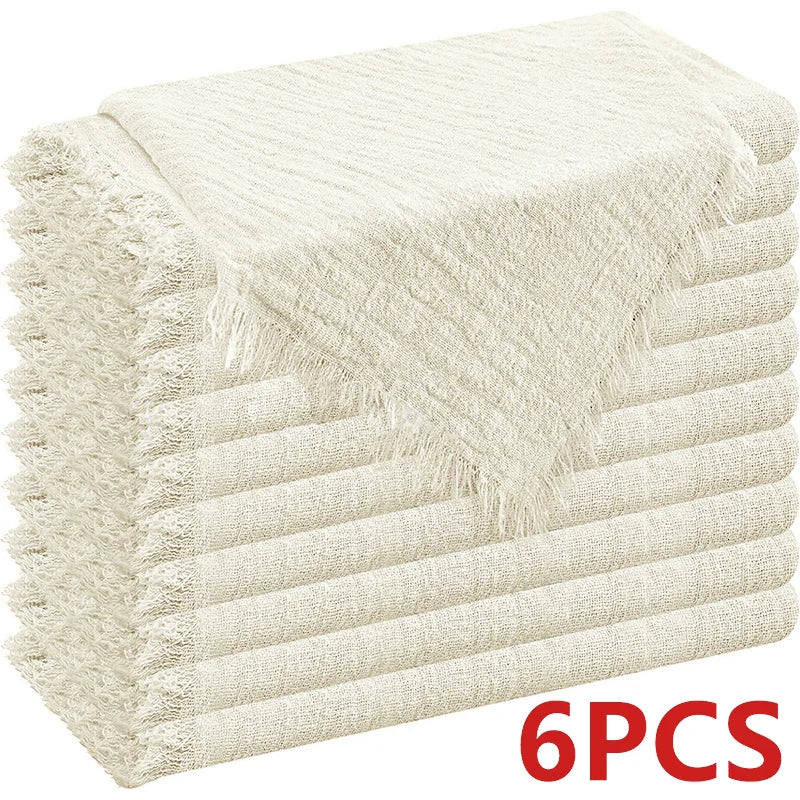 A stack of six beige raw-edge polyester cloth napkins.