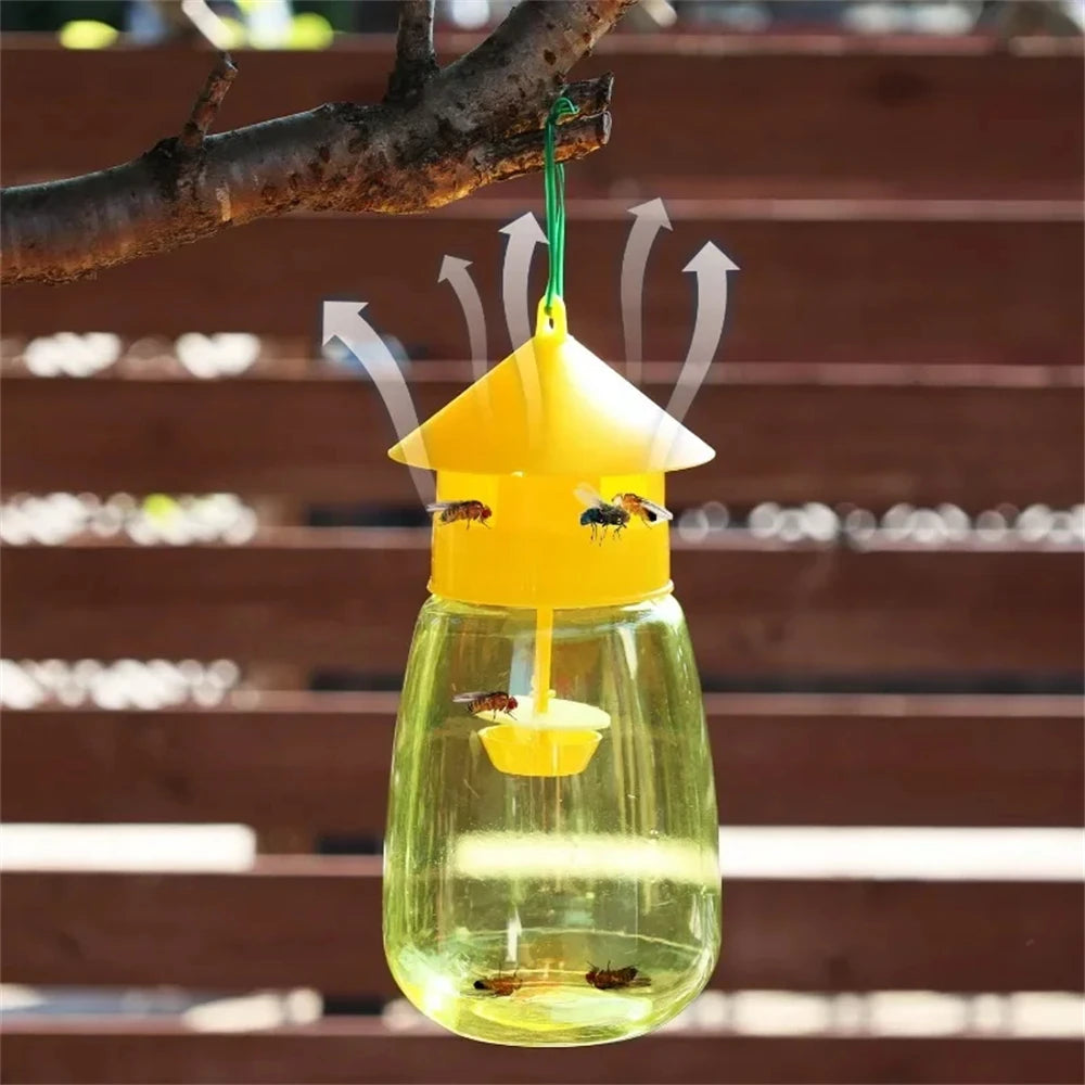 A yellow fruit fly trap kit with a pheromone lure suspended from a branch.