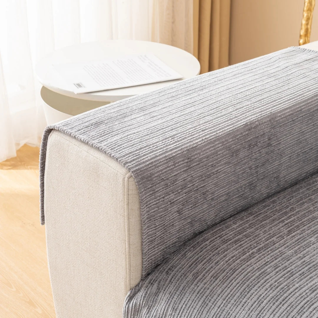 A close-up of a gray striped sofa cushion cover on a light-colored sofa.