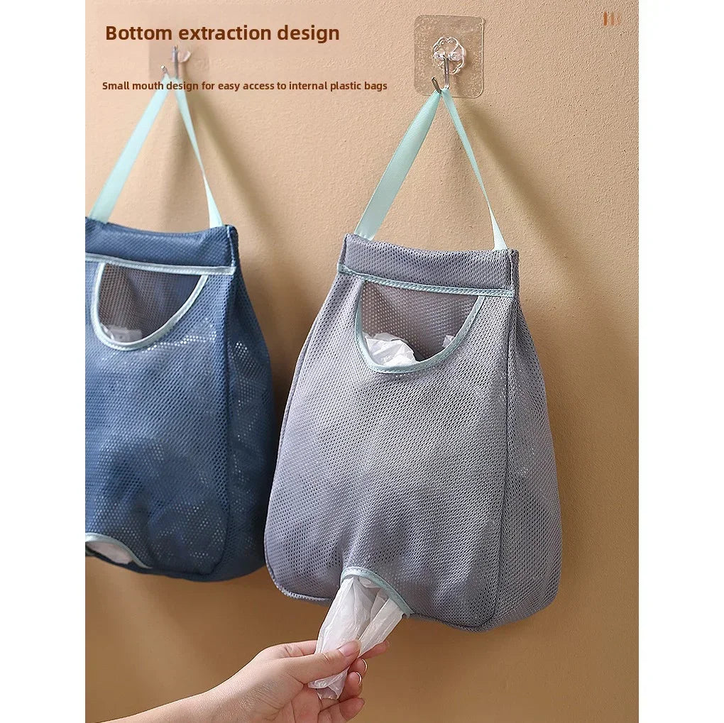 A gray mesh garbage bag holder is shown hanging on a wall, designed for bottom extraction.