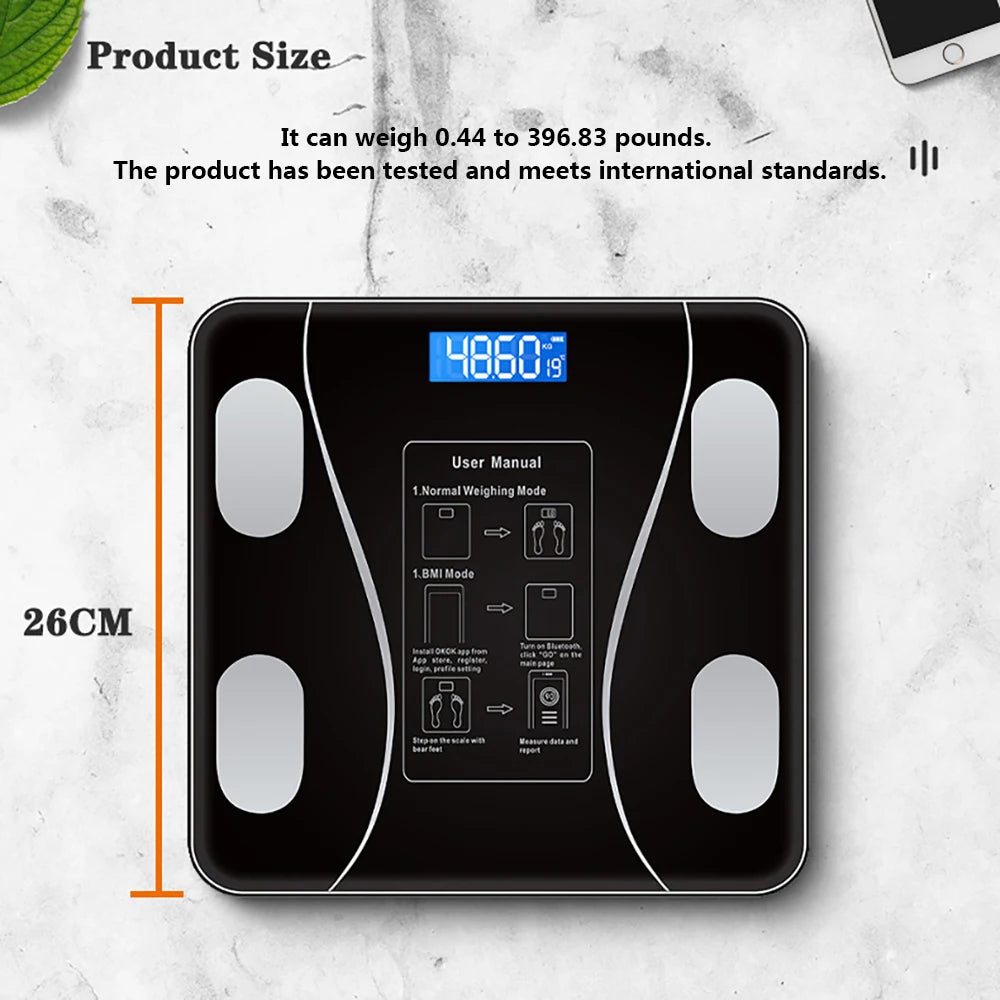 A black smart body composition scale is shown with a user manual diagram and dimensions.
