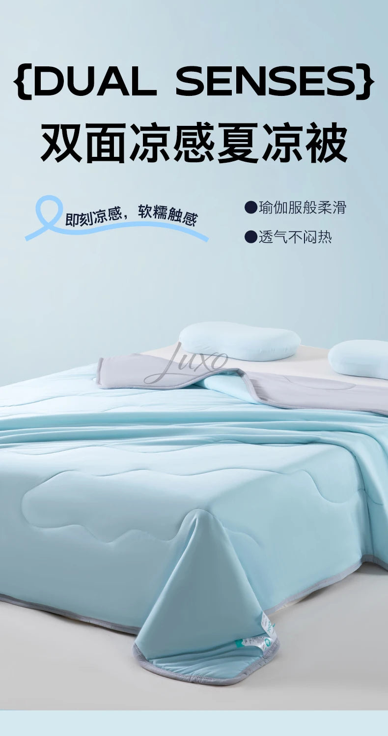 A light blue ice silk cooling blanket is shown folded on a bed with a pillow and a rolled-up section.