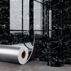Roll of self-adhesive marble wall sticker for kitchen and bathroom displayed against a black marble background.