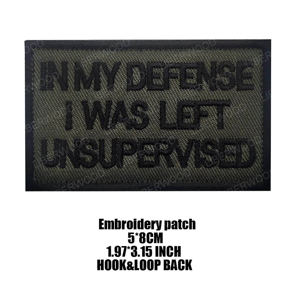 Black embroidered patch with white text reading IN MY DEFENSE I WAS LEFT UNSUPERVISED
