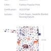 A white fabric diaper or swaddle blanket featuring a pattern of various woodland animals like deer, bears, and rabbits.