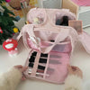 A pink cosmetic travel organizer with multiple compartments and a mesh pocket is shown being held by hands.