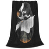 A black blanket featuring a stylized white silhouette of a figure with flowing hair and a snowflake design.