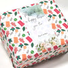 Rechteckige Box mit Dankesversiegelungsstickern mit floralen und grünen Designs auf weißem Hintergrund.