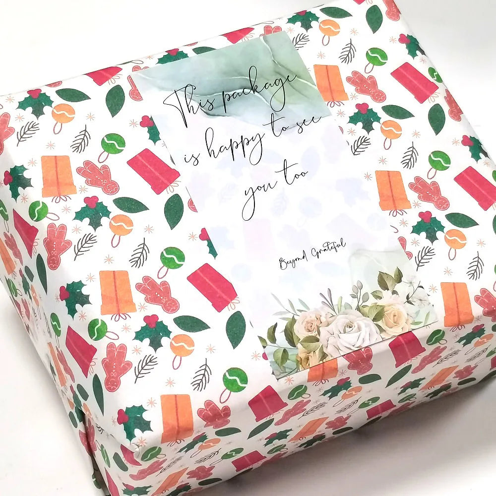 Rechteckige Box mit Dankesversiegelungsstickern mit floralen und grünen Designs auf weißem Hintergrund.