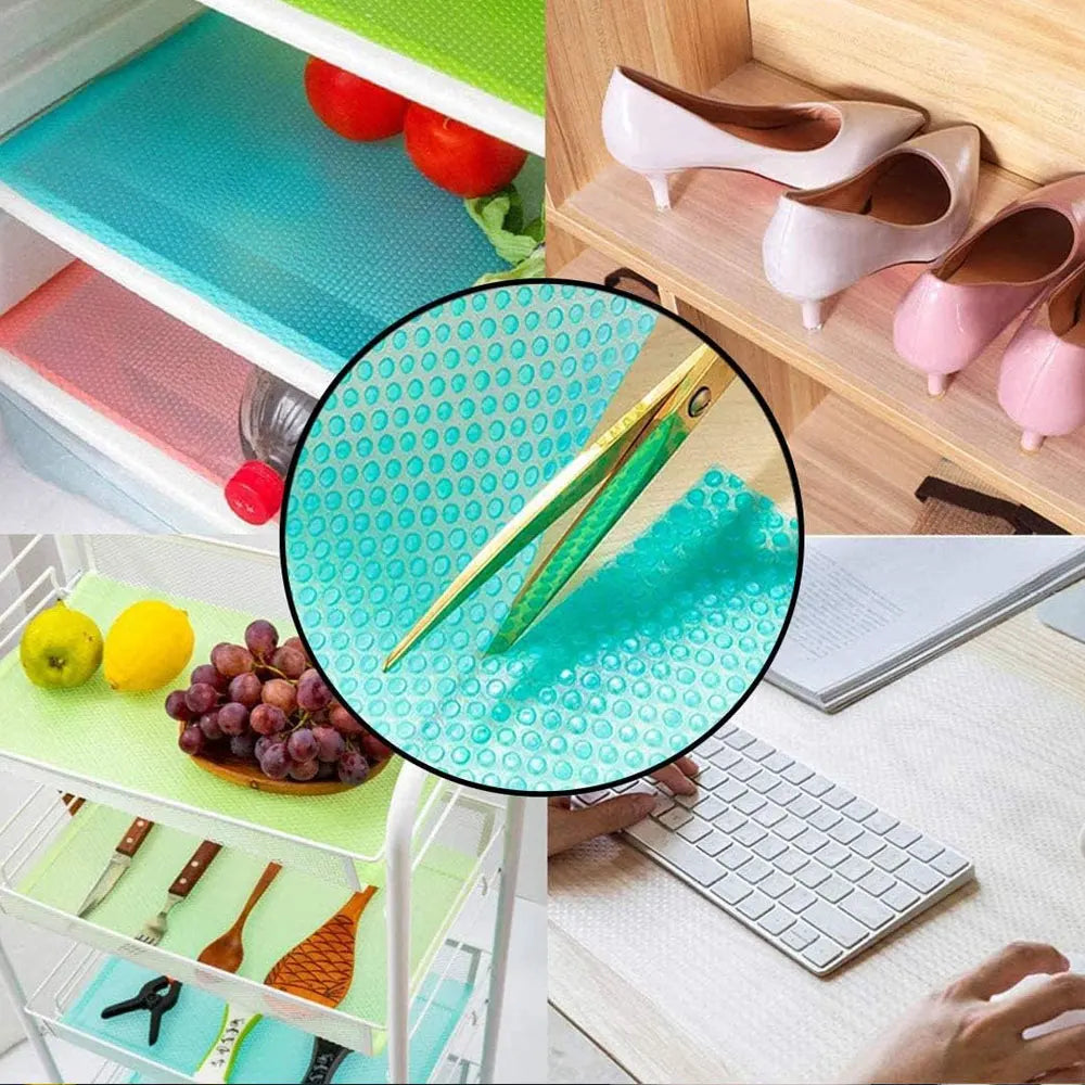 A set of colorful waterproof refrigerator liner mats and a pair of pink shoes displayed next to a laptop.