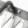 Close-up view of a manganese steel weeding rake with sharp blades and a metal handle.