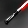 A close-up view of a Neo Pixel lightsaber with a glowing red blade and silver hilt against a dark background.