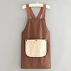 A brown striped waterproof kitchen apron with a removable beige towel hanging on a wooden hanger.