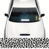 A white car windshield covered with a leopard print sunshade decal strip.