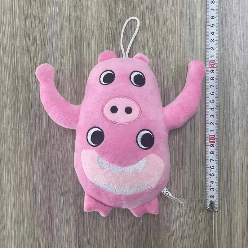 Pink plush toy of a pig with large eyes and a smiling mouth