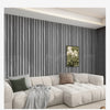 A modern living room featuring a light beige sofa against a dark gray vertical wood grain wallpaper.