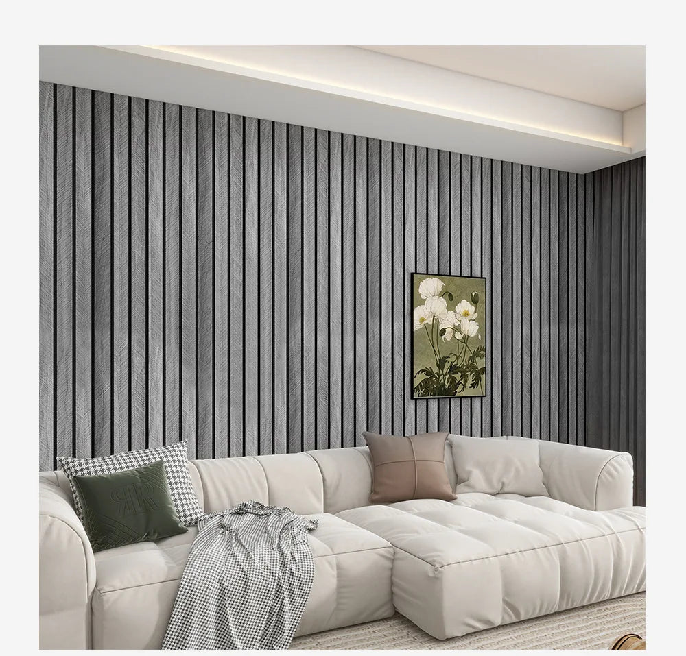 A modern living room featuring a light beige sofa against a dark gray vertical wood grain wallpaper.