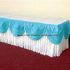 Elegant ice silk table skirt with matching top swag in white and light blue for a wedding.