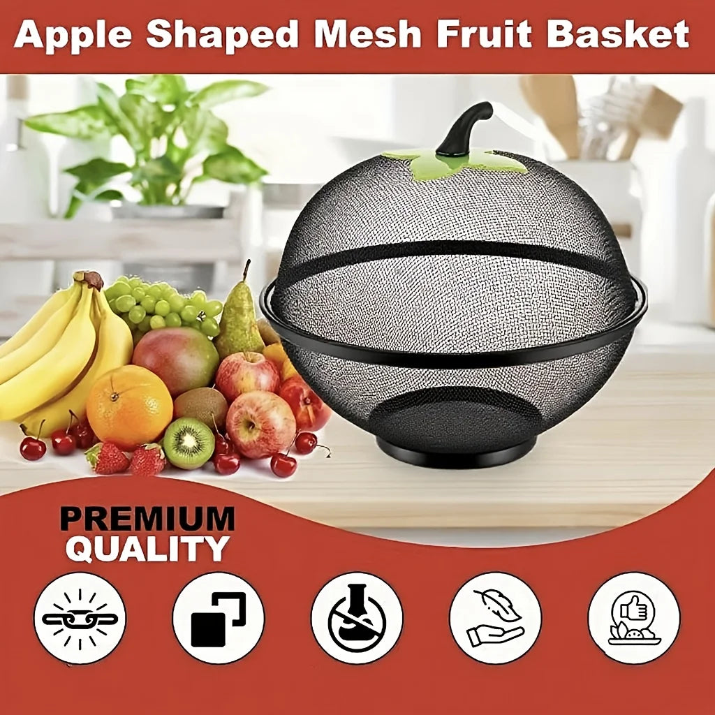 Black apple-shaped mesh fruit basket filled with various fruits on a wooden surface.