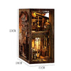 A wooden DIY book nook kit featuring a detailed 3D puzzle bookshelf insert with ornate carvings and glass elements.