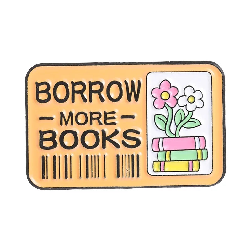 An enamel pin featuring the text BORROW MORE BOOKS on a rectangular yellow background with a floral design.