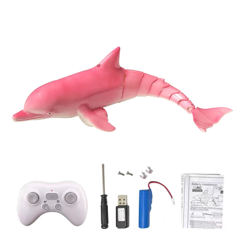 A pink remote control shark toy with a water spray, along with its battery and accessories.