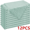 A stack of light mint green raw-edge polyester cloth napkins.