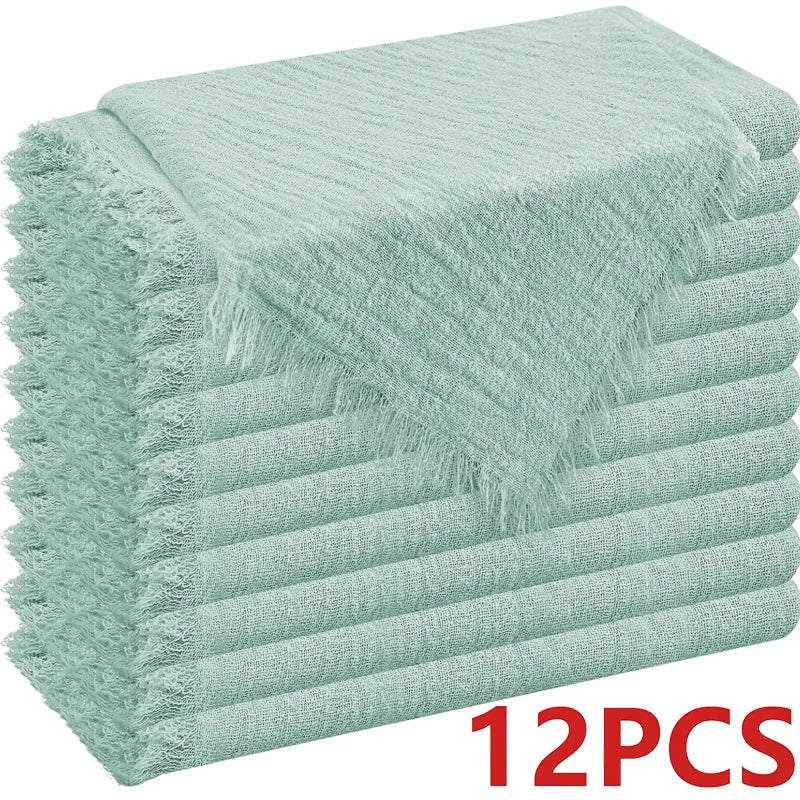A stack of light mint green raw-edge polyester cloth napkins.