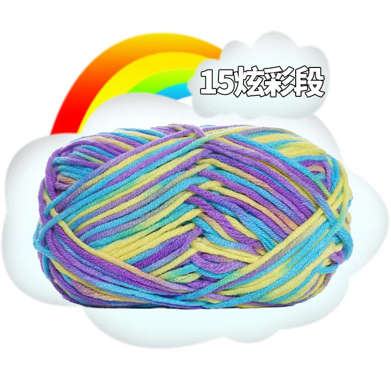 A ball of multi-colored milk cotton blend yarn with purple, blue, yellow, and green strands, displayed against a white cloud 