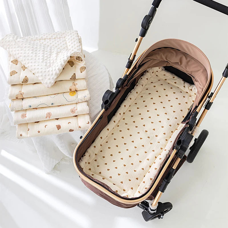 A brown baby stroller seat cushion with padded support is shown next to a stack of white and floral patterned fabric.