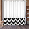 White shower curtain featuring a black wavy geometric stripe pattern hanging from a metal rod.
