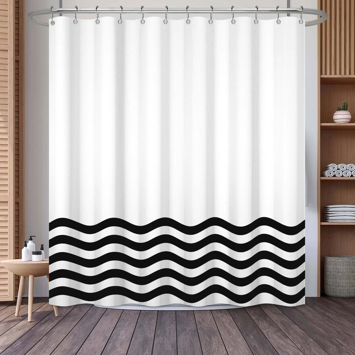 White shower curtain featuring a black wavy geometric stripe pattern hanging from a metal rod.
