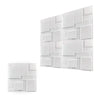 A close-up view of white 3D diamond textured wall panels arranged in a modern geometric pattern.