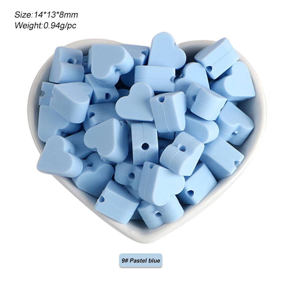 A pile of light blue silicone heart and star-shaped beads for DIY jewelry making