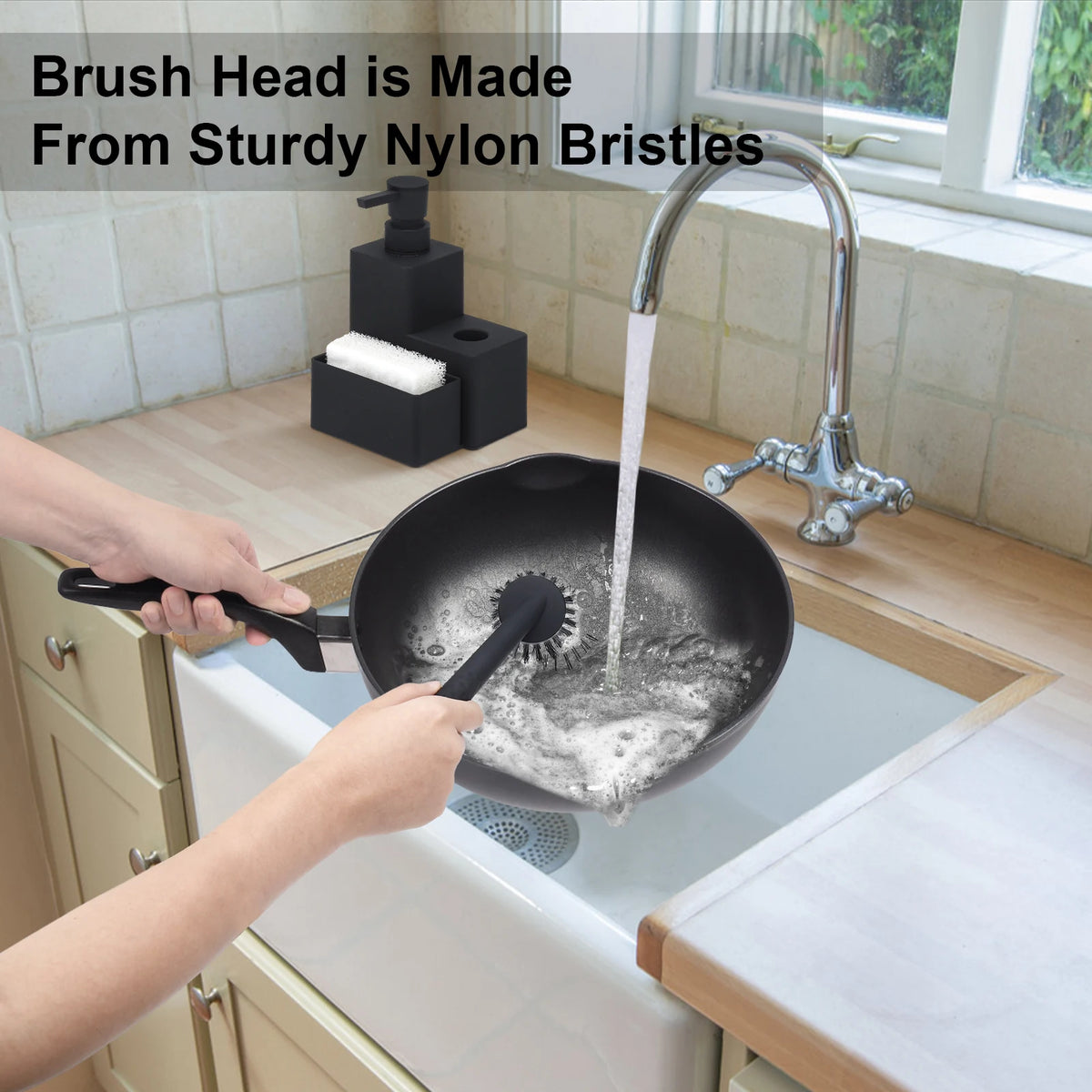 Hands are using a brush head made from sturdy nylon bristles to clean a pot in a kitchen sink.
