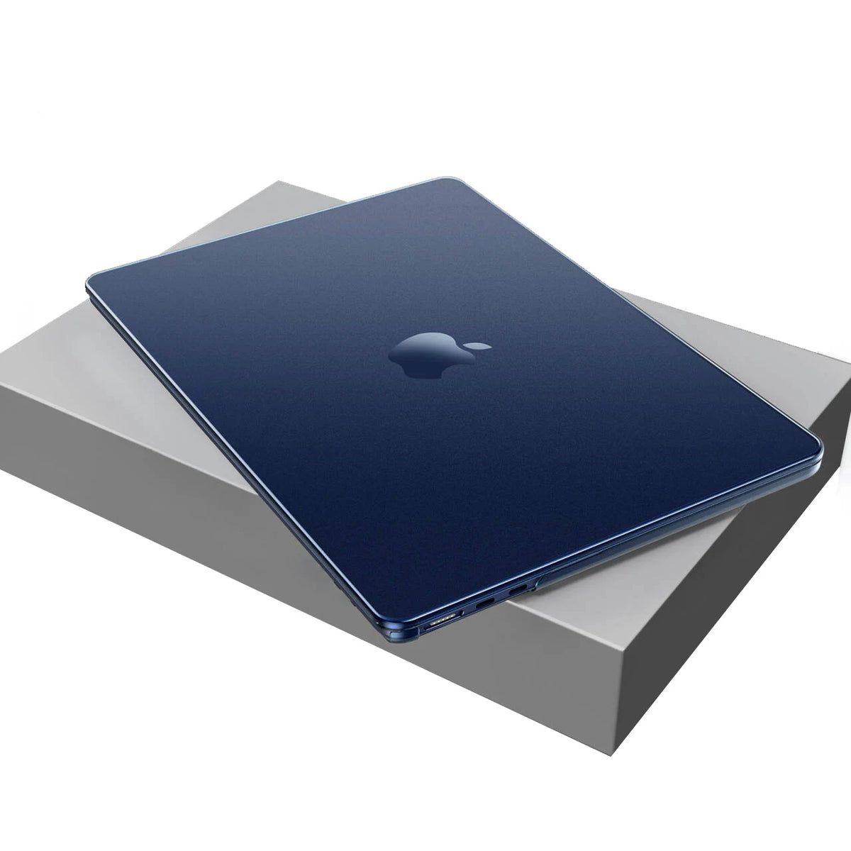 A dark blue MacBook Air is placed on a gray protective case.