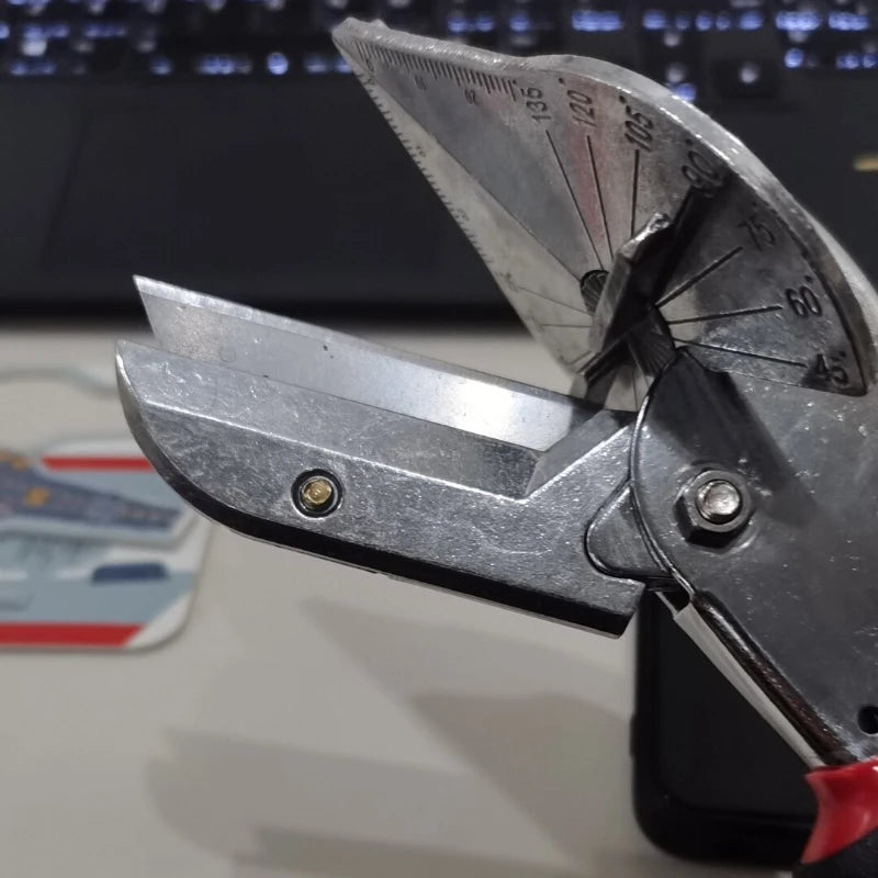 A close-up of an adjustable angle shear tool with a marked scale, used for cutting PVC and PE pipes.