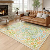 A rectangular soft carpet mat featuring a floral vine pattern in shades of green, orange, and white on a light wood floor.