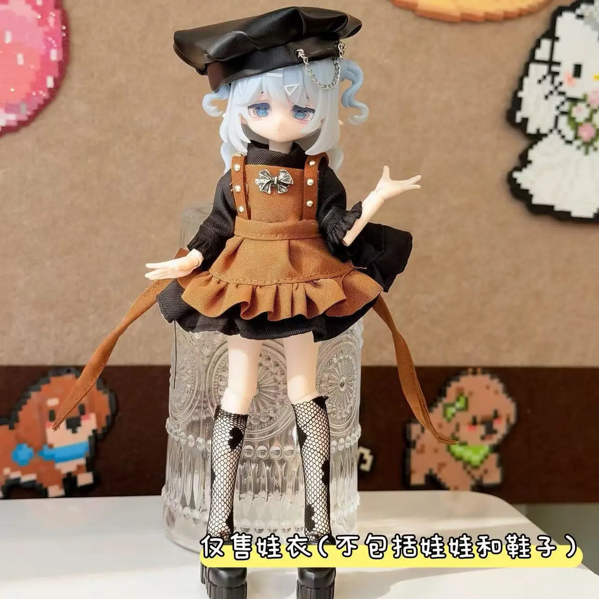 A female BJD doll wearing a black and brown maid dress outfit with a black cap and long gloves.