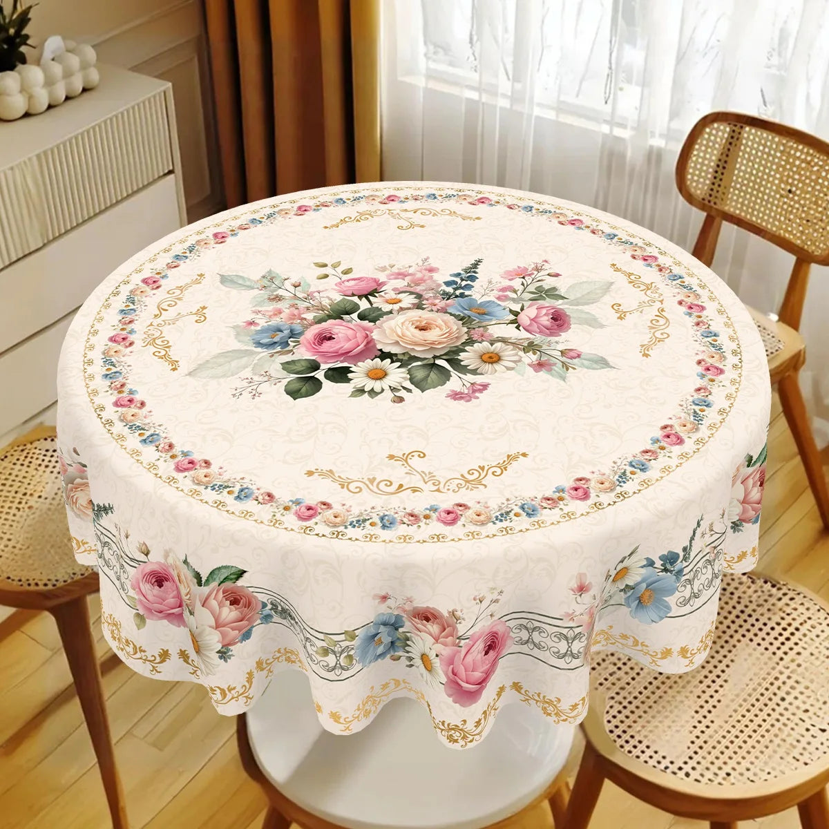 Vintage floral tablecloth with pink and blue roses decorating a round dining table set.