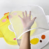 A hand is placed inside a yellow mesh bag shaped like a duck, which is used as a bath toy storage item.